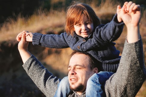 Young child having a shoulder ride